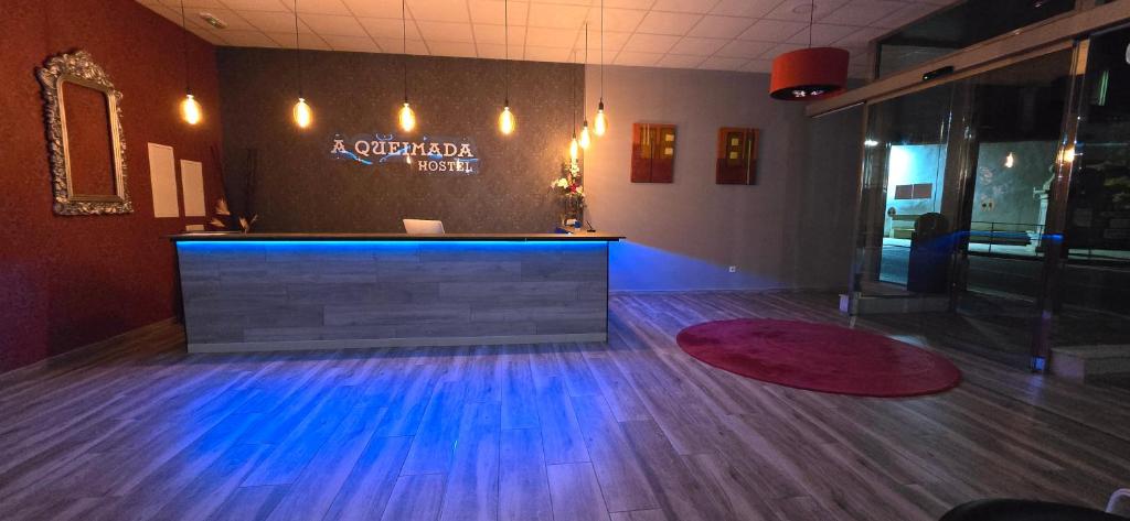 a lobby with a dance floor with blue lights at ALBERGUE a QUEIMADA in Caldas de Reis