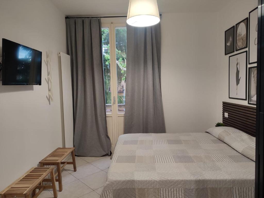 a bedroom with a bed and a window at Casa André in Imola