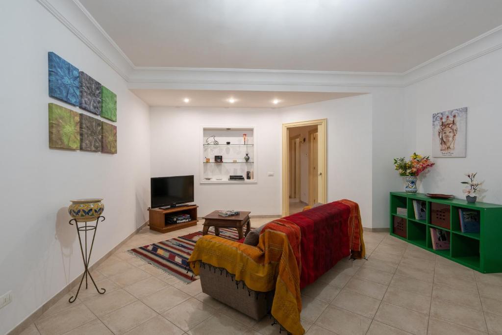 a living room with a couch and a tv at Villa Cecilia in Sciacca