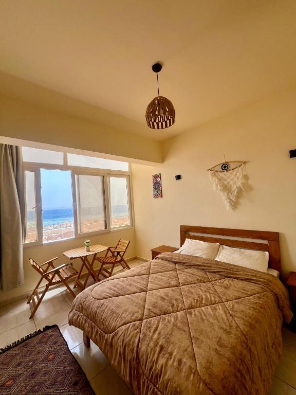 a bedroom with a bed and a view of the ocean at Tree House Hotel Dahab in Dahab