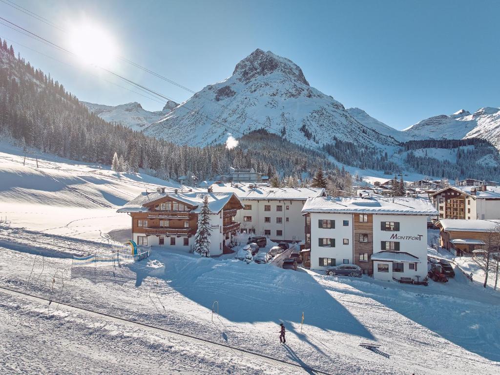 a person is skiing down a snow covered mountain at Fürmesli Appartements in Lech am Arlberg