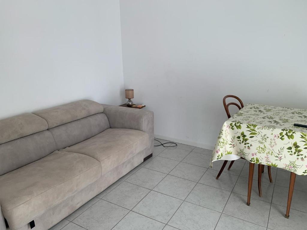 a living room with a couch and a table at La Stella Marinella in Santa Marinella