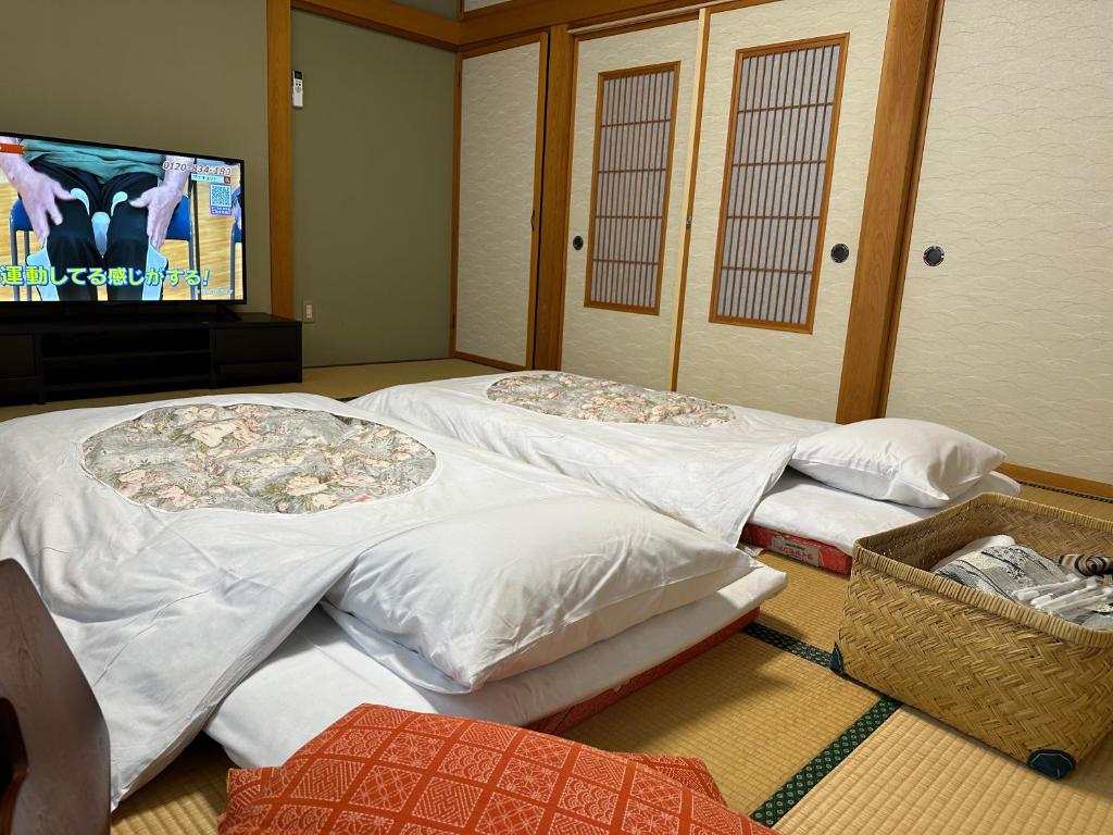 Postel nebo postele na pokoji v ubytování レイクピアエンゼル山中湖