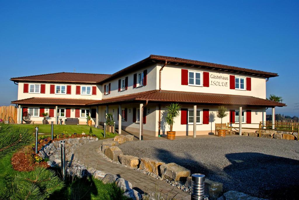 a large house with a driveway in front of it at Gasthaus Amboss in Ravensburg