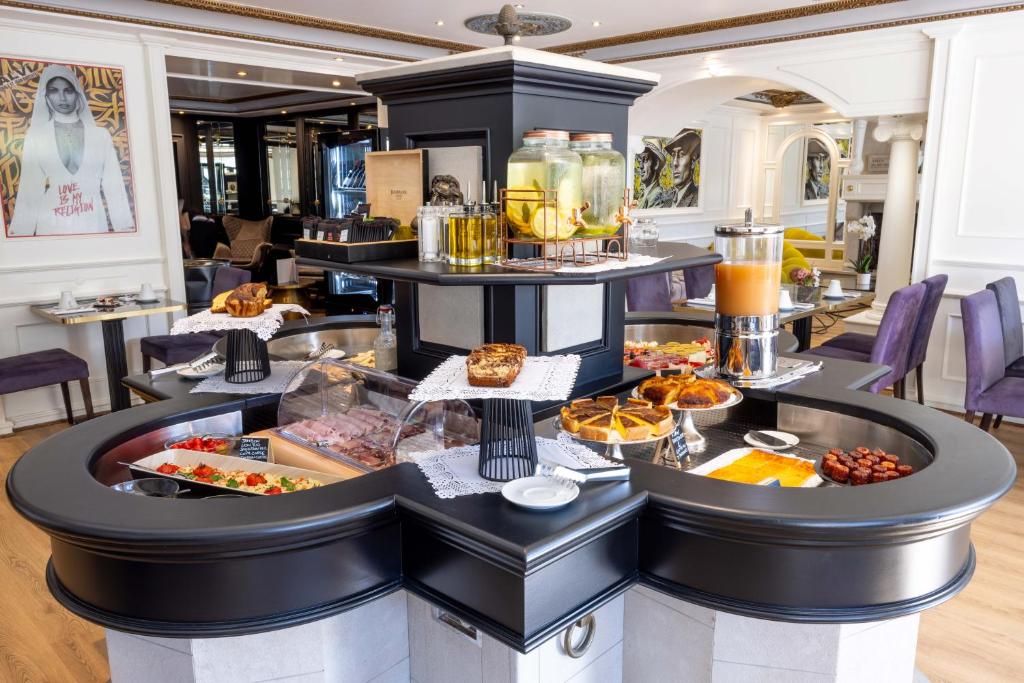 a breakfast buffet at a hotel with food on display at Hôtel L'Abbaye in Calvi