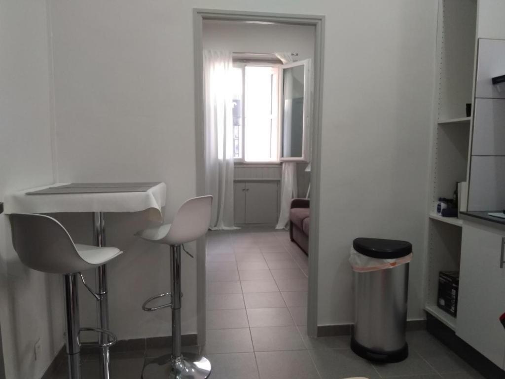 - une cuisine avec un évier et deux tabourets dans une pièce dans l'établissement Studio avec canapé-lit, à Banyuls-sur-Mer