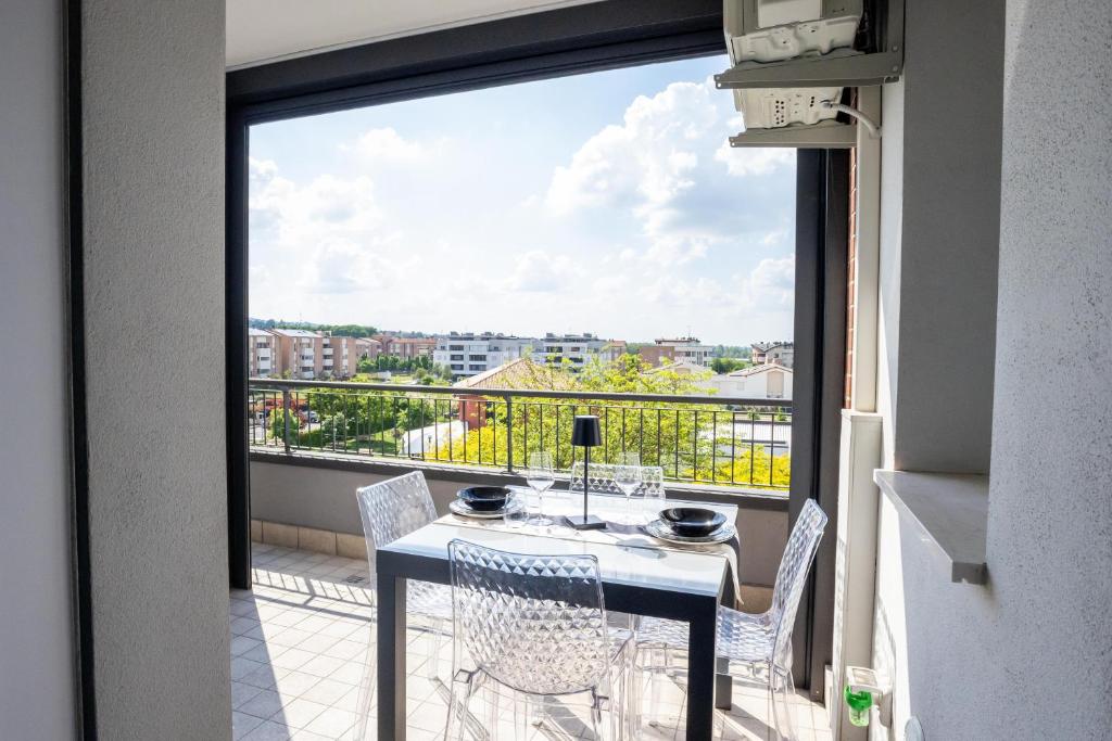 a balcony with a table and chairs and a view at Le Ninfee in Zola Predosa