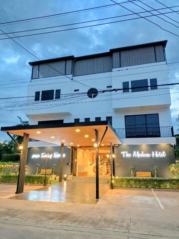 a building with a sign that reads the modern house at The Modeva Hotel in Kanchanaburi