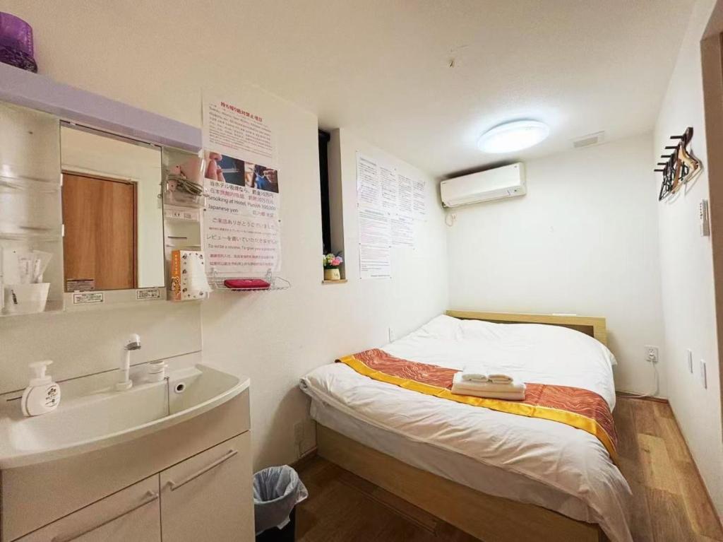 Postel nebo postele na pokoji v ubytování 花乃郷 池袋b