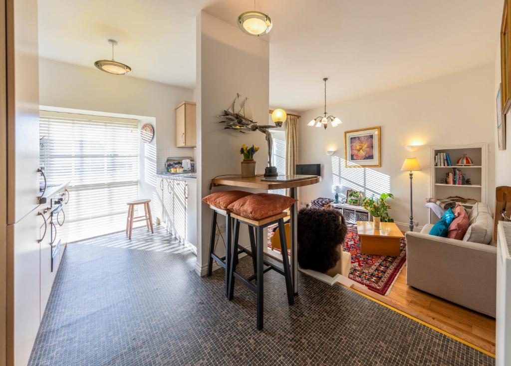 a kitchen and living room with a table and a couch at City Centre Haven in Perth