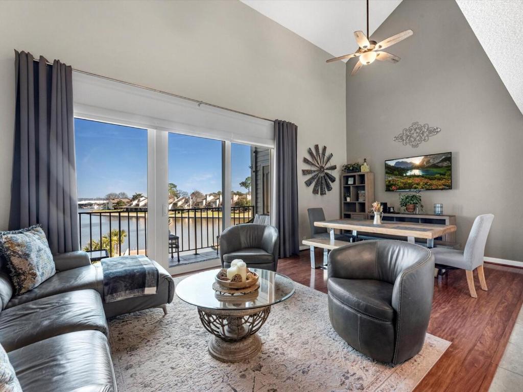 a living room with a couch and a table at Lakefront Condo Retreat in Montgomery