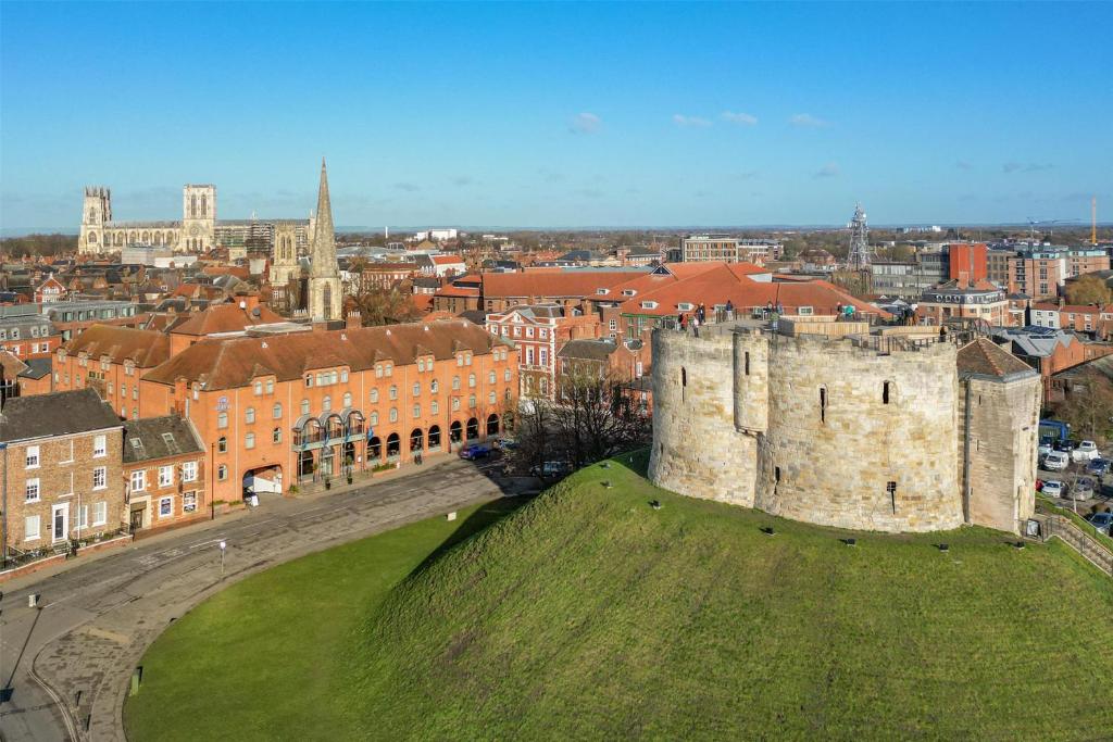 an old castle on top of a green hill at Hilton York in York