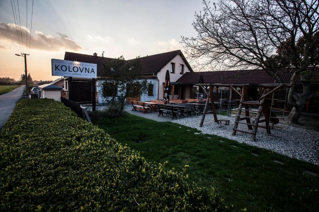 a building with a sign that says koonymka on it at Penzion Kolovna in Dobrá