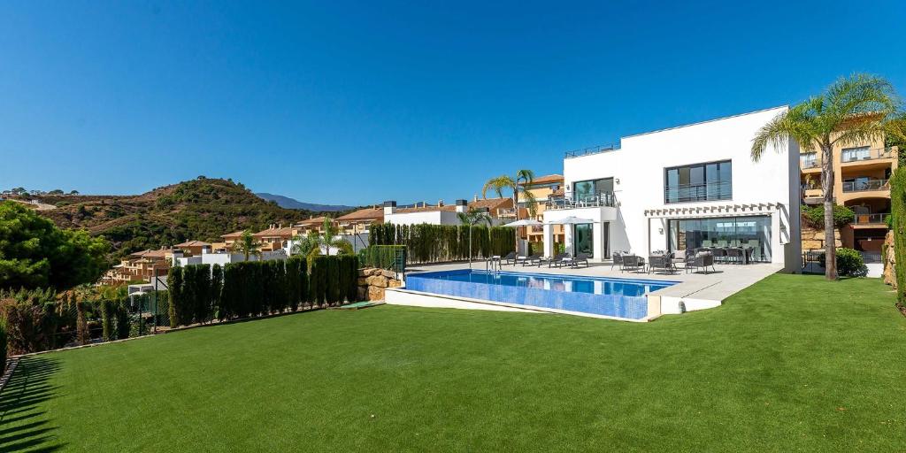 a house with a large yard with a swimming pool at VACATION MARBELLA I Villa De La Resina, Infinity Pool, Golf Community, Africa Views in Estepona