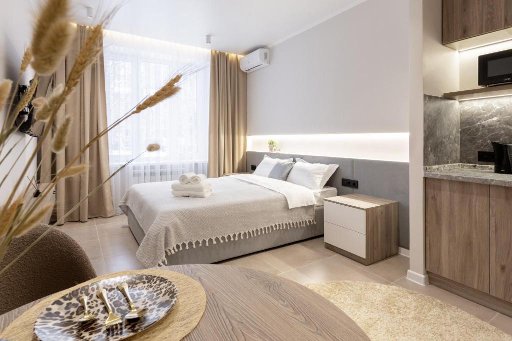 a hotel room with a bed and a table at The First Apart Hotel in Almaty