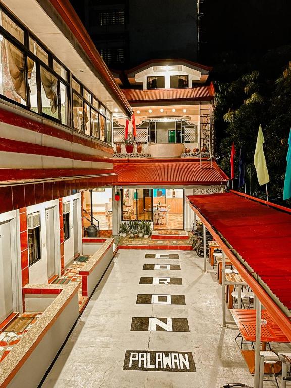 a building with a train in the middle of it at Mario's Travellers Inn in Coron