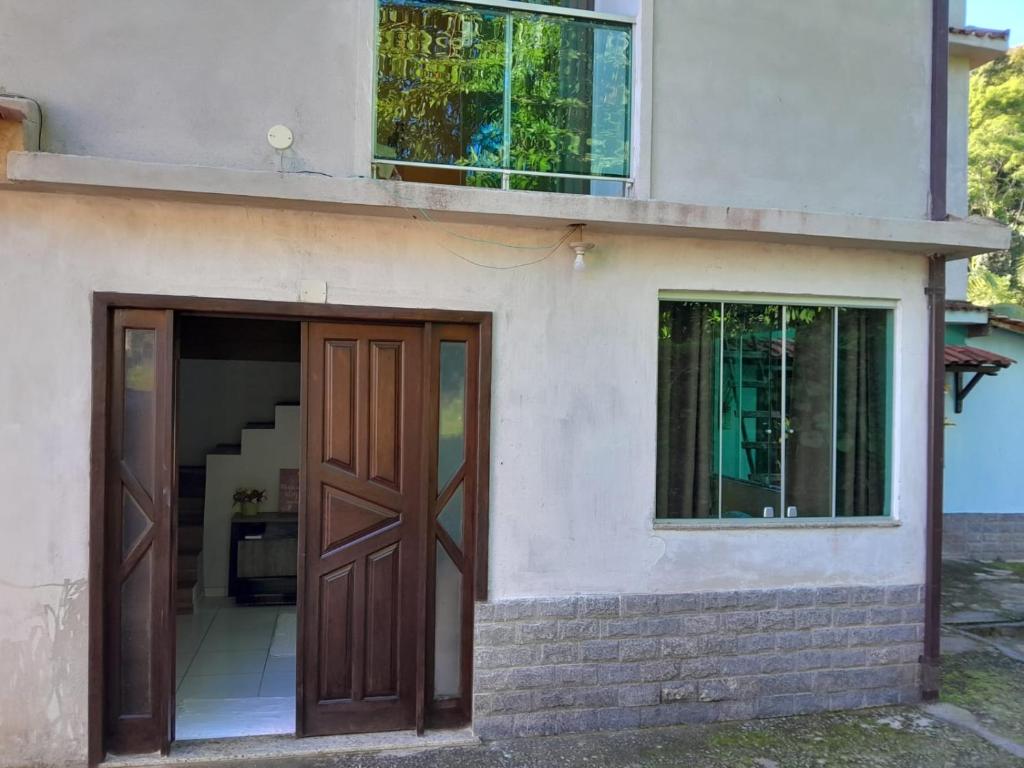 a house with a door and a window at Recanto verde pousada in Angra dos Reis