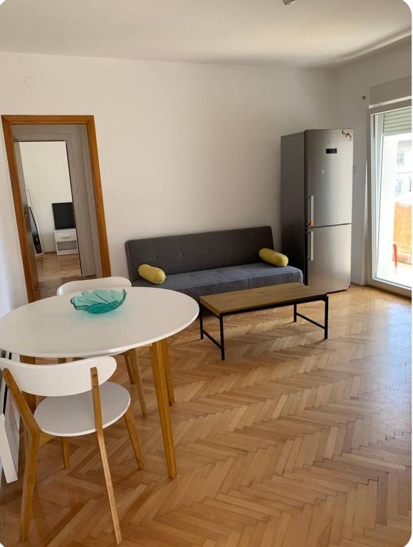 a living room with a table and a refrigerator at Sunny in Split