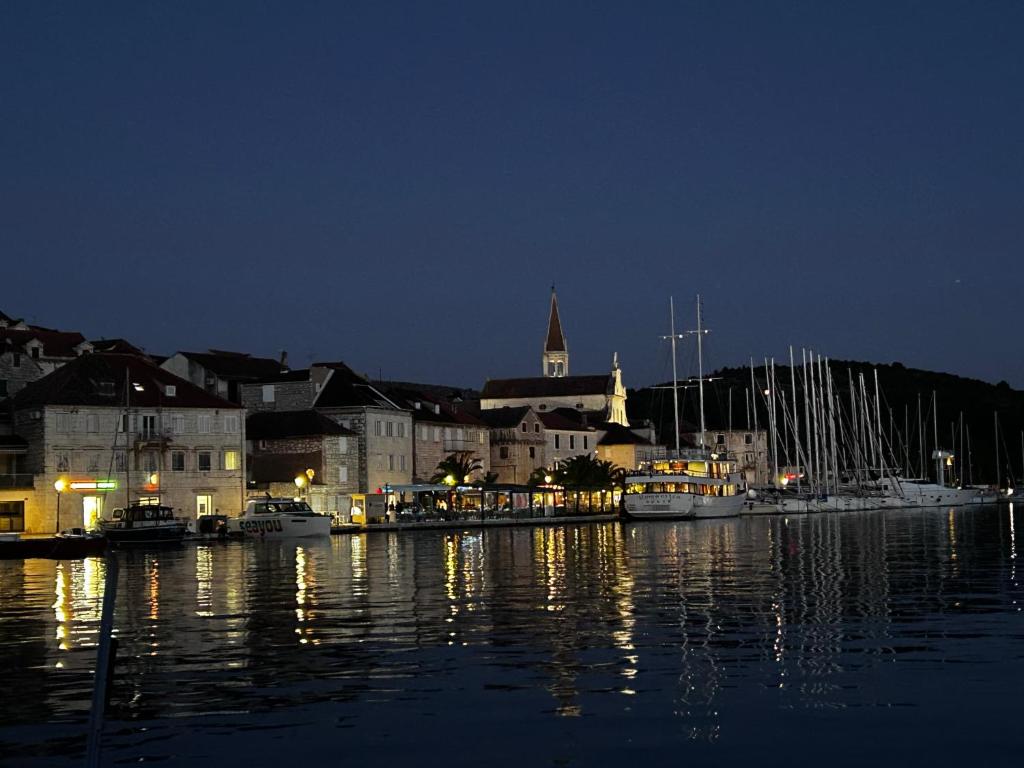a group of boats docked in a harbor at night at Apartment Milna Dante in Milna
