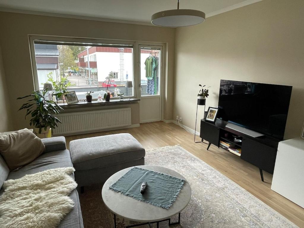 a living room with a couch and a table at Newly renovated, spacious flat! in Uppsala