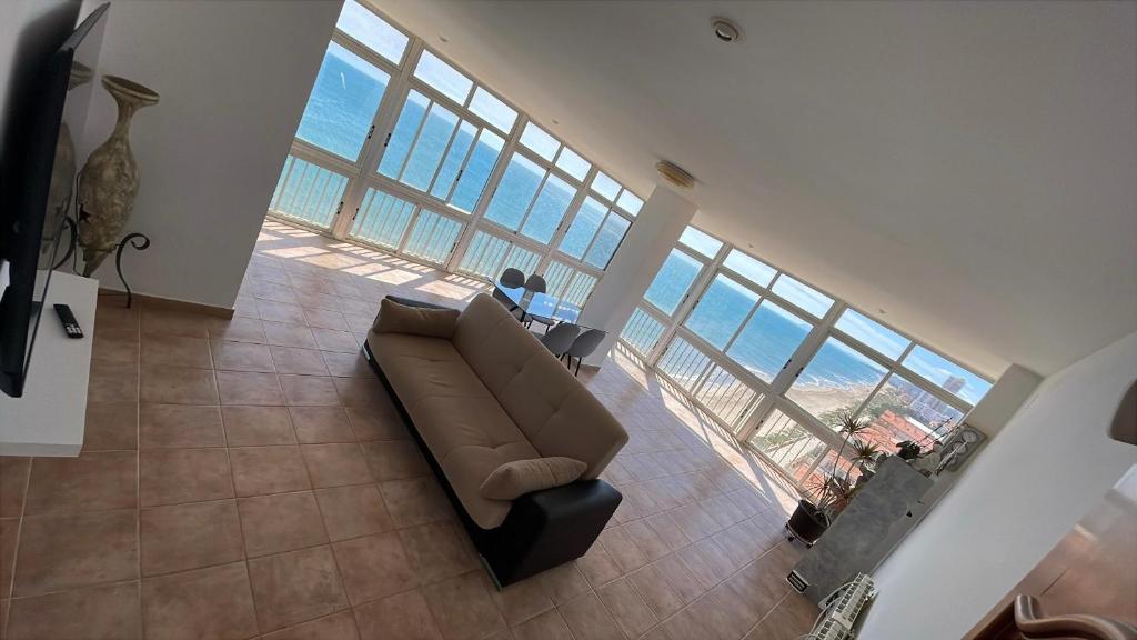 a living room with a couch and a view of the ocean at Apartamento Rey I in Valencia