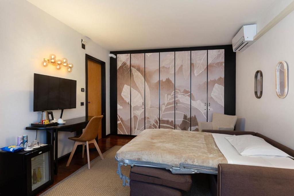Postel nebo postele na pokoji v ubytování Hotel Ancora