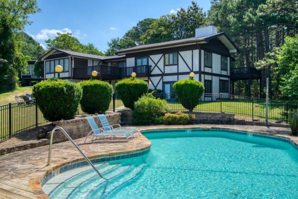 a house with a swimming pool in front of a house at Hidden Oasis Near Downtown in Eureka Springs