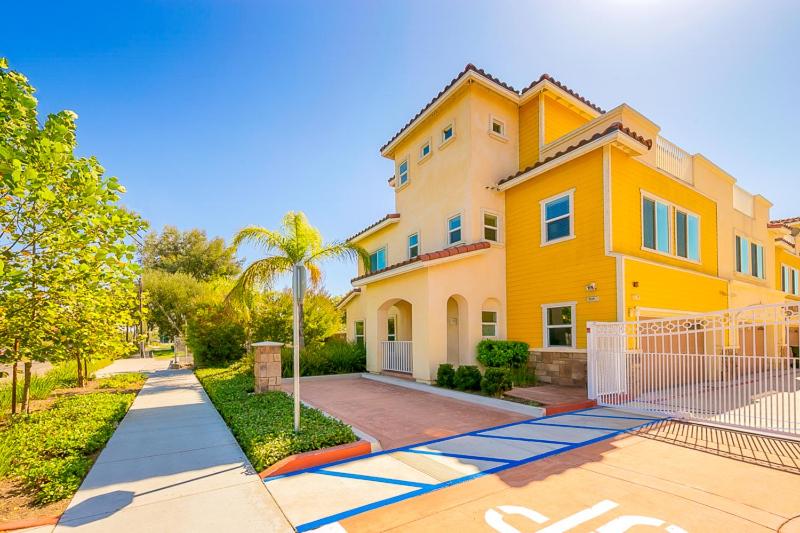 a large yellow house with a gate in front of it at F-56 Winnie the Poohs Treehouse in Anaheim