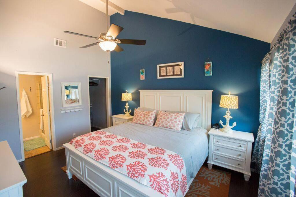a bedroom with a bed and a blue wall at Under the Sea by Funtierland Vacation Rentals in Anaheim