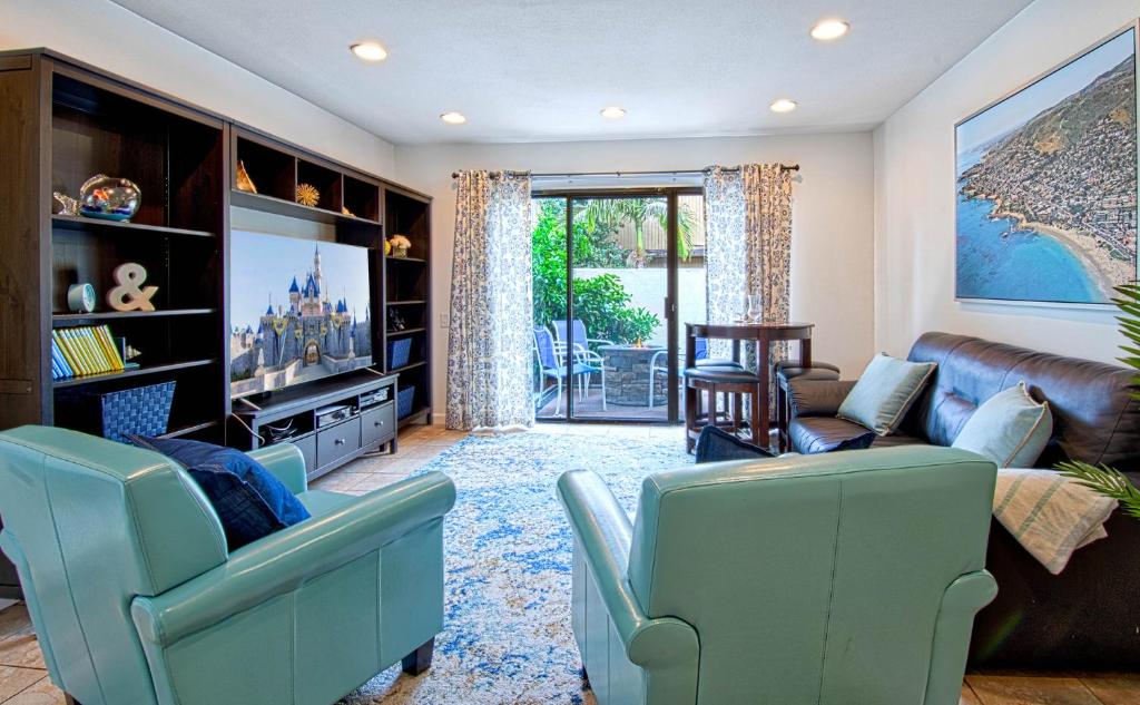 a living room with a couch and a tv at Tron by Funtierland Vacation Rentals in Anaheim