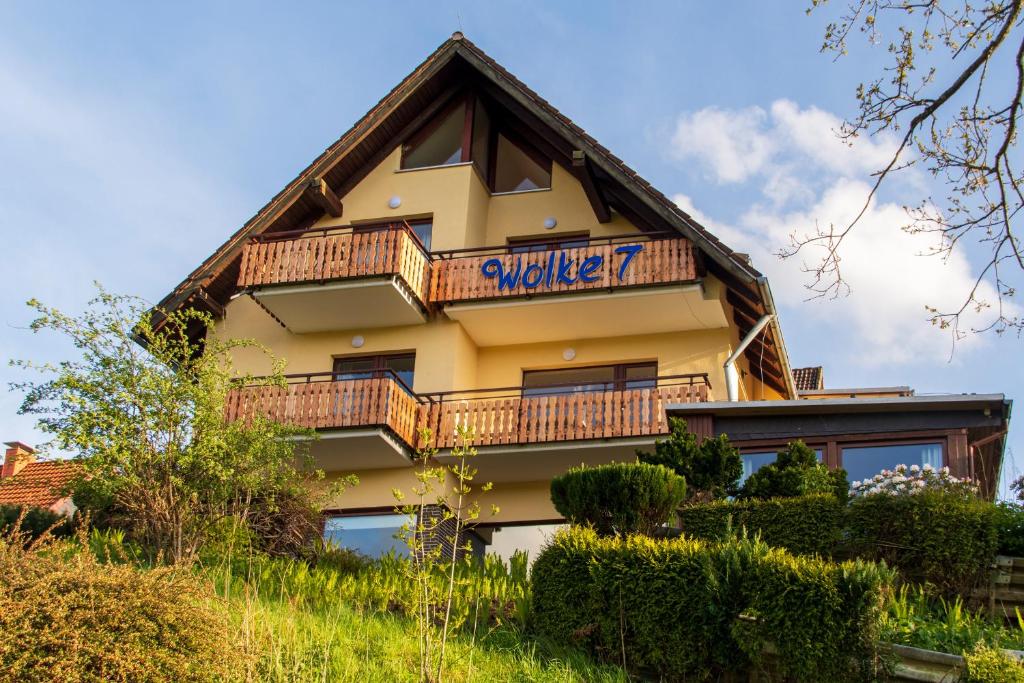a building with a balcony on the side of it at Ferienhaus Wolke 7 in Sankt Andreasberg