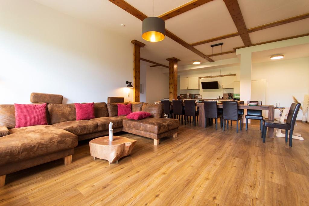 a living room with a couch and a dining room at Ferienhaus Wolke 7 in Sankt Andreasberg