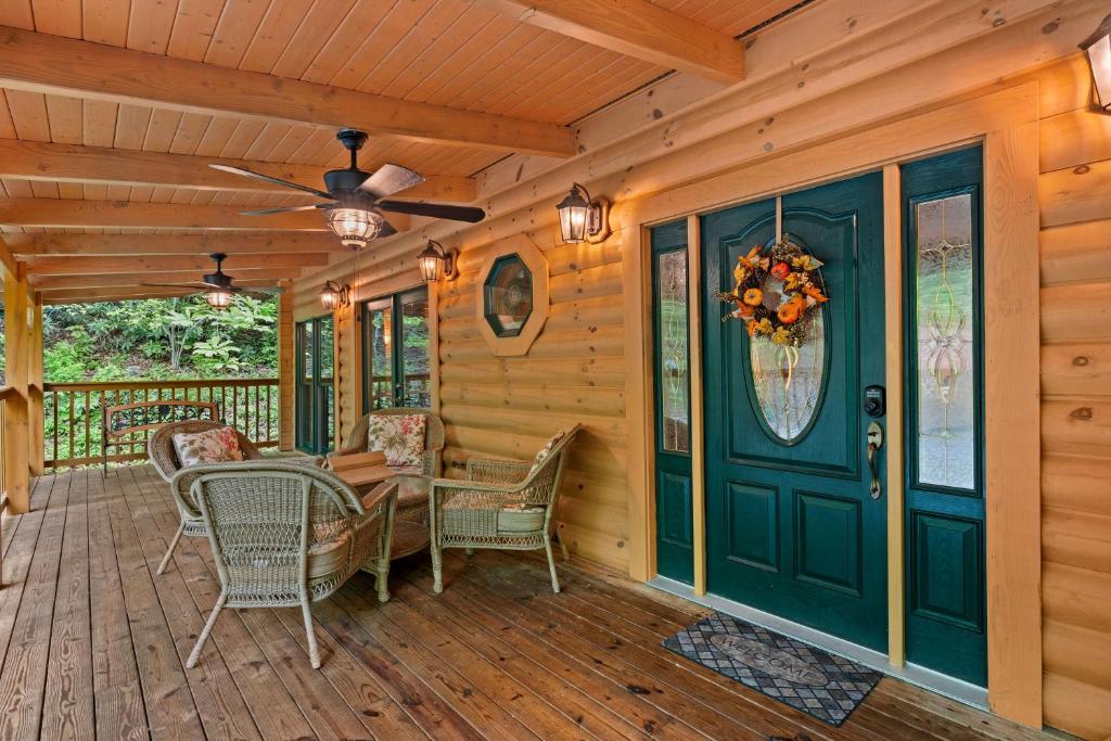 a porch with a table and chairs and a ceiling fan at Elk Rapids on Cosby Creek in Cosby