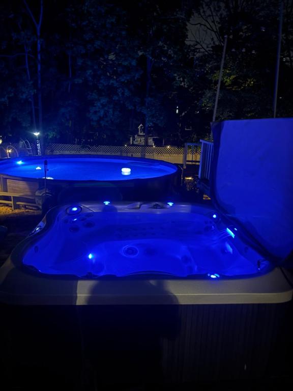 a blue jacuzzi tub in a yard at night at Bloom Victorian Bed & Breakfast in South Orange