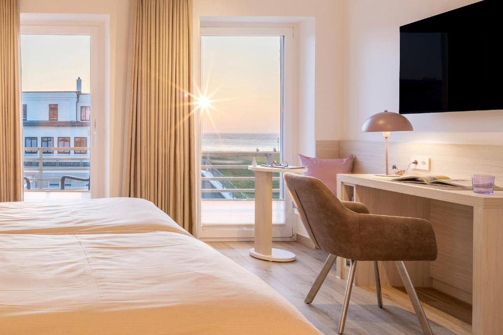 Postel nebo postele na pokoji v ubytování Hotel Stranddistel