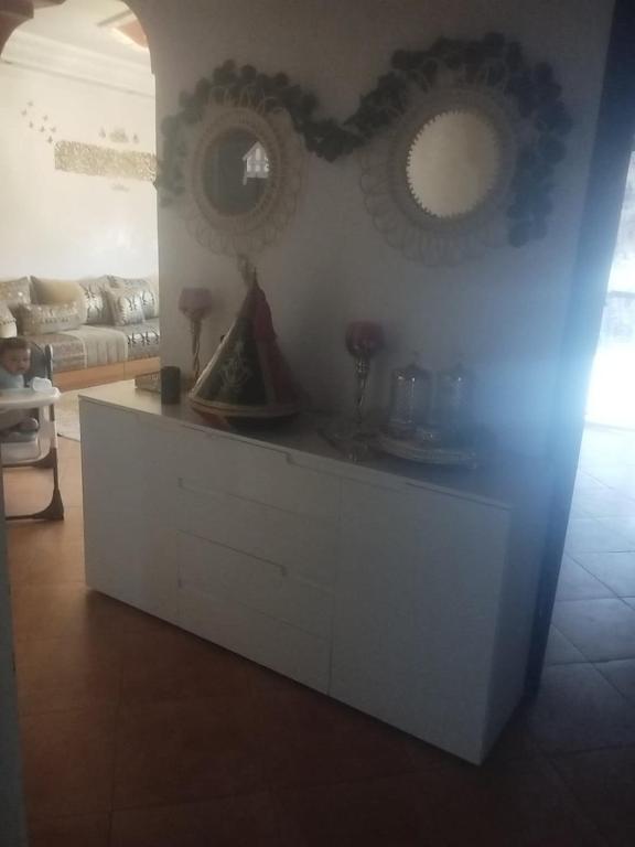 a white cabinet in a living room with a couch at Apartment Dar Salam in Marrakesh