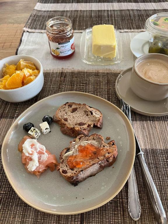 a plate of food on a table with bread and fruit at Dingqin'Home in Arni Alp