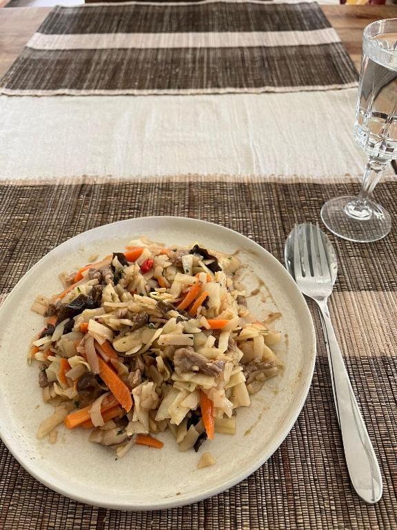 a plate of rice and vegetables on a table at Dingqin'Home in Arni Alp