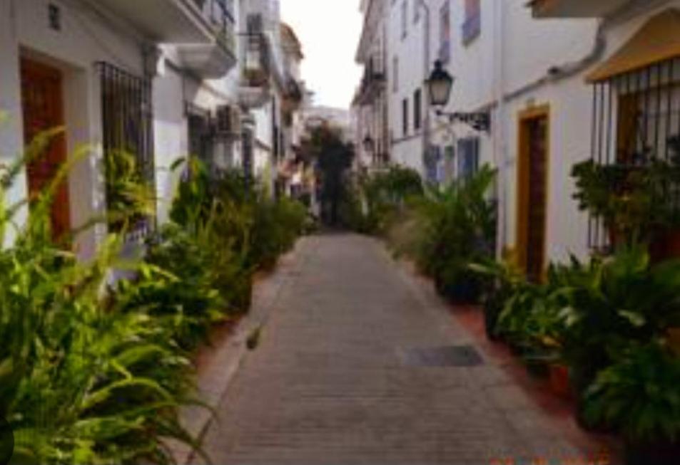 an empty alley way in a city with buildings at Casa en Marbella Centro con encanto in Marbella