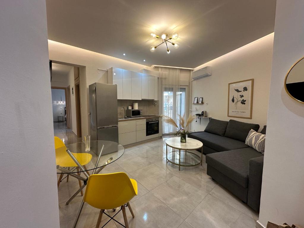 a living room with a couch and a table at Agora by Rapsani beach ! in Kavála