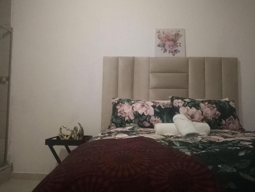 a bedroom with a bed with a large headboard at Khetshane Consortium private park and restaurants in Ntswanahatshe