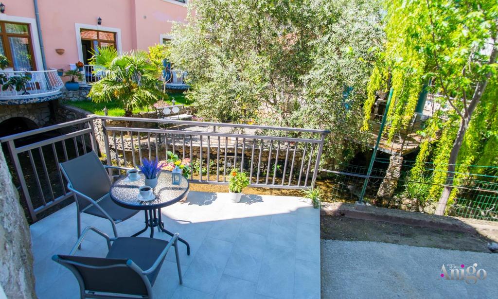 a patio with a table and chairs and a fence at Stari View-Free Parking in Mostar