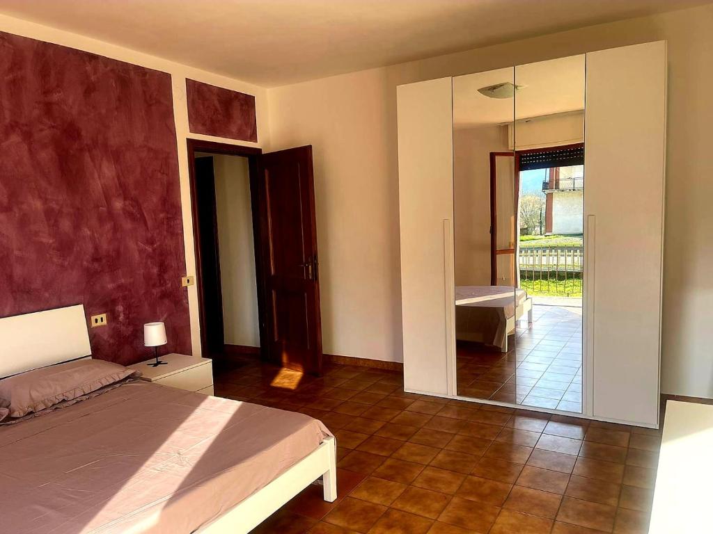 a bedroom with a bed and a large mirror at Appartamento da Cece - Filattiera in Filattiera