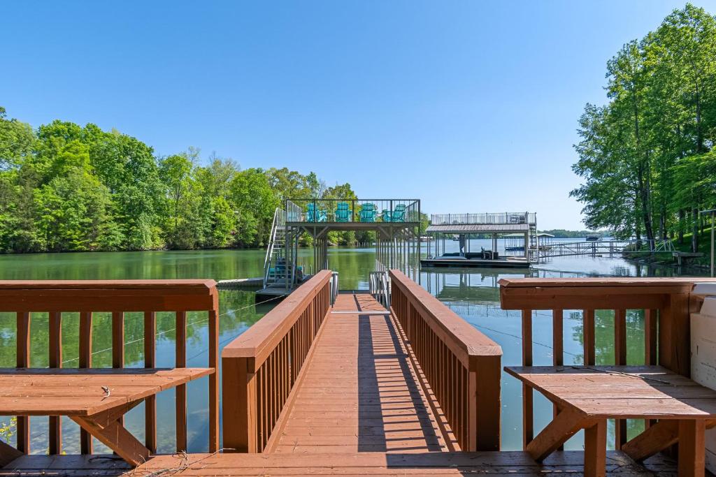 a dock with benches and a bridge over the water at Lucky Dozen Lakehouse in Winchester