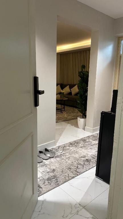 a room with a door and a living room with a couch at شقه لليله جميله ومريحه in Al Khobar