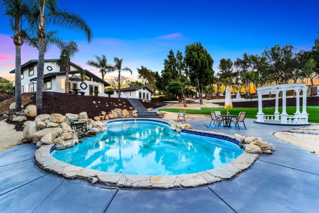 a swimming pool in a yard with a landscaping at The Grand Vista Getaway in Vista