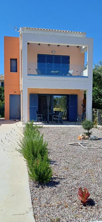 a large house with a patio in front of it at Agrilia in Lefkada