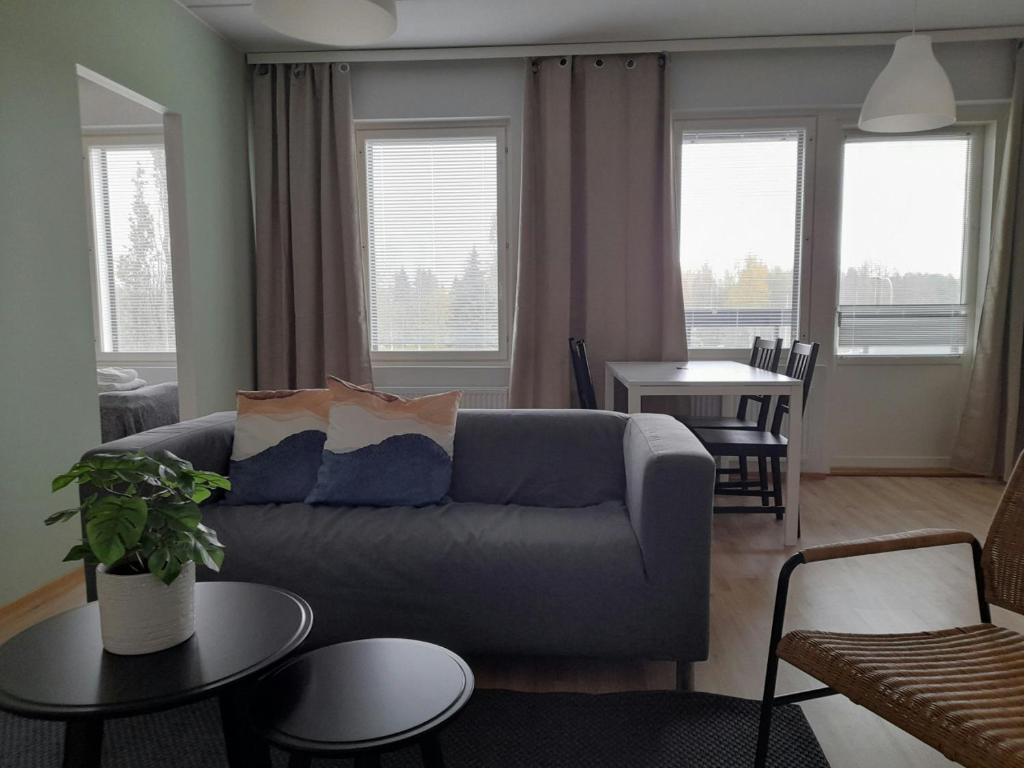 a living room with a couch and a table at Convenient Apartment for 3 in Oulu