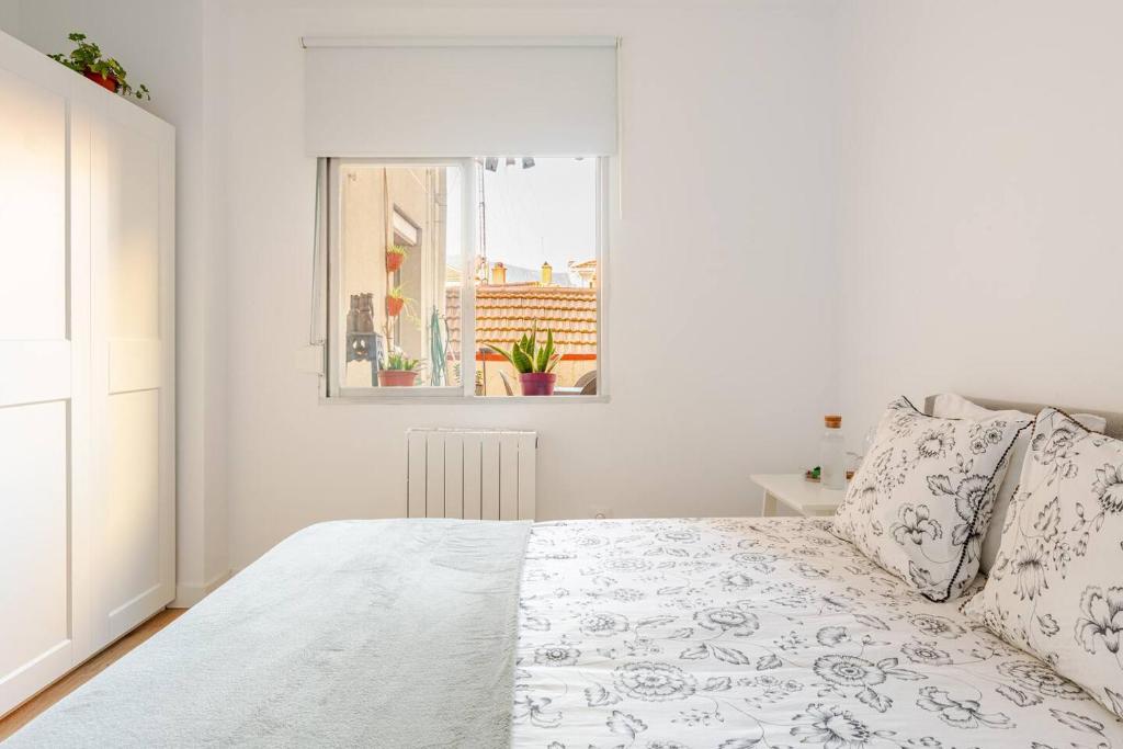 a white bedroom with a bed and a window at Habitación privada en el centro de Bilbao in Bilbao