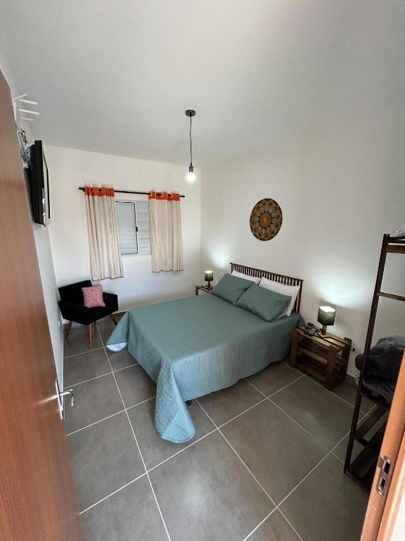 a bedroom with a green bed in a room at Casa da Vila in Monte Alegre do Sul